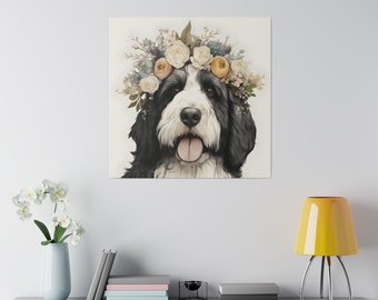 May include: A square canvas print featuring a black and white dog with a floral crown. The dog has a happy expression with its tongue out. The crown includes white, yellow, and blue flowers. The print is displayed on a white wall.