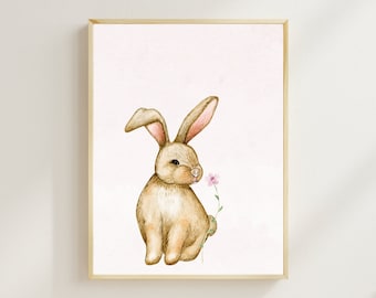 May include: A watercolor painting of a brown bunny rabbit sitting and smelling a pink flower on a light pink background.