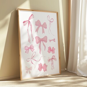 May include: A digital print featuring a collection of pink watercolour bows in various styles and sizes. The bows are arranged in a random pattern on a white background.