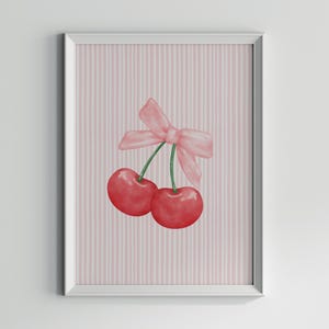 May include: Two red cherries with green stems and a pink bow on a pink and white striped background.