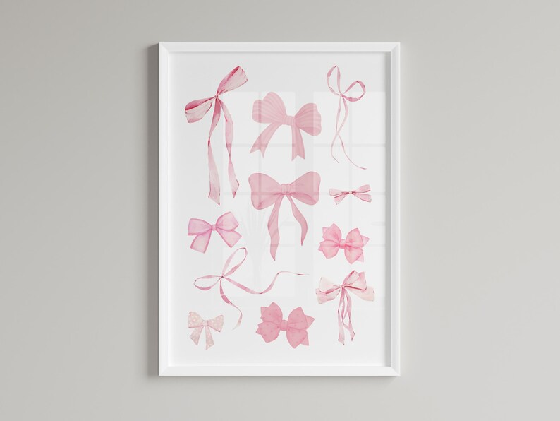 May include: A white framed print featuring a watercolour illustration of pink bows in various sizes and shapes.