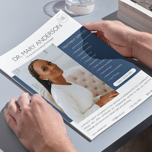 May include: A brochure held by hands, featuring Dr. Mary Anderson, Clinical and Counseling Psychologist. The brochure has a photo of a woman and lists treatment services such as individual and couples counseling. Contact information is included.