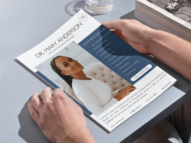 May include: A brochure held by hands, featuring Dr. Mary Anderson, Clinical and Counseling Psychologist. The brochure has a photo of a woman and lists treatment services such as individual and couples counseling. Contact information is included.