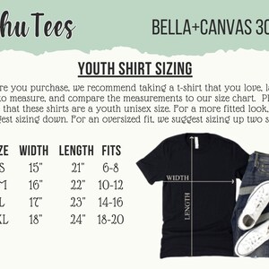 May include: Black t-shirt with youth shirt sizing information. The chart shows sizes YS (15" width, 21" length), YM (16" width, 22" length), YL (17" width, 23" length), and YXL (18" width, 24" length). Includes text "Schu Tees" and "BELLA+CANVAS 3001Y".