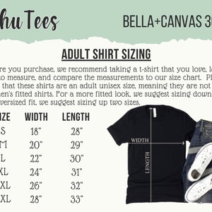 May include: Black t-shirt with a size chart, jeans, and white sneakers. The chart shows adult shirt sizing with measurements in inches for width and length. The text on the shirt says "Schu Tees" and "BELLA+CANVAS 3001".
