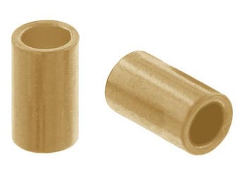 May include: Two gold-colored metal tube spacers. The spacers are cylindrical and have a smooth, shiny finish.