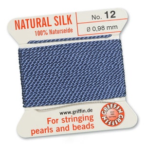 May include: A spool of natural silk thread in a muted blue color. The label reads "NATURAL SILK" and "For stringing pearls and beads." The thread is 0.98 mm in diameter. The brand name "Griffin" is also visible.