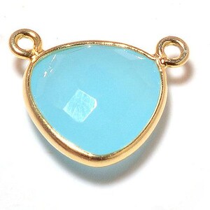 May include: A light blue gemstone pendant with gold-toned metal accents. The pendant has a teardrop shape and is perfect for adding a touch of elegance to any jewelry project.
