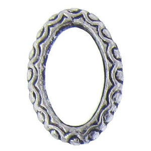 May include: A silver oval-shaped ring with a decorative, textured design.