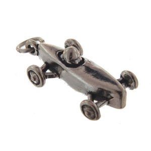 May include: A silver charm in the shape of a race car. The car has a driver in the cockpit and four wheels.