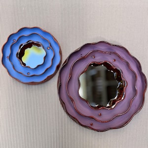 Handmade flower-shaped wall mirrors in purple and blue glazed ceramic frames, decorative scalloped mirror set, unique artistic home decor.
