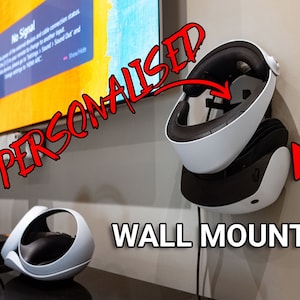 May include: A white and black virtual reality headset mounted on a wall with the text "PERSONALISED WALL MOUNT!" in red.