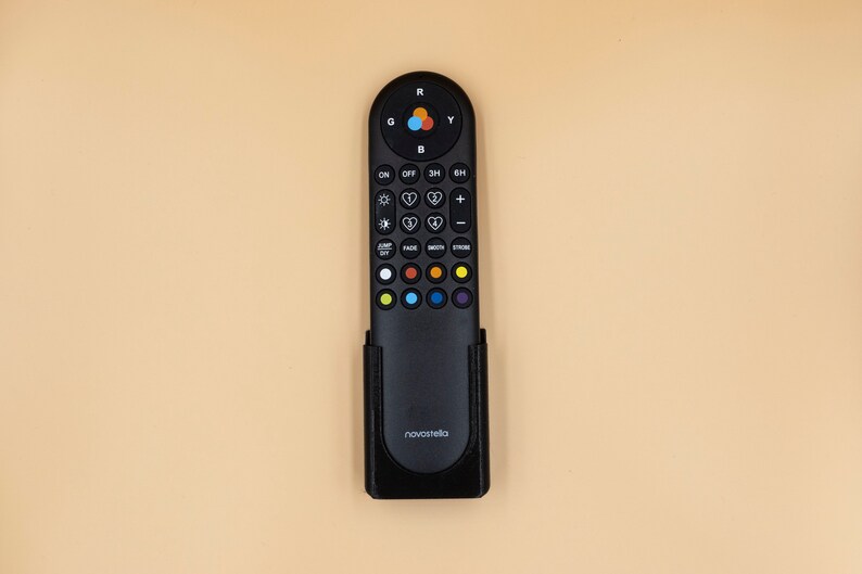 May include: Black remote control with multiple buttons for controlling lighting. The remote has buttons labeled "ON", "OFF", and others for adjusting brightness and color. The brand name "novastella" is printed on the bottom.