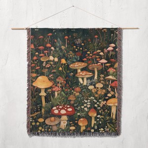 May include: A tapestry wall hanging featuring a dark green background with a variety of colorful mushrooms in different sizes and shapes. The mushrooms are arranged in a random pattern and are surrounded by green leaves and flowers.