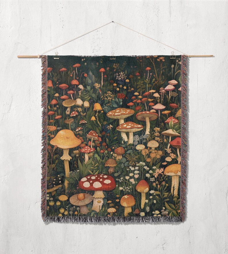 May include: A tapestry wall hanging featuring a dark green background with a variety of colorful mushrooms in different sizes and shapes. The mushrooms are arranged in a random pattern and are surrounded by green leaves and flowers.