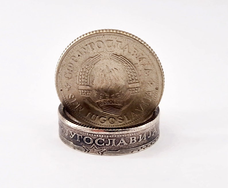 May include: A silver ring made from a Yugoslavian coin. The ring features the text "SRPSKA JUGOSLAVIJA" and a star design.