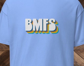 May include: A light blue t-shirt with the text "BMFS" in white letters with a rainbow colored outline.