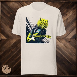 May include: White t-shirt with a graphic of a cat playing an electric guitar. The cat is wearing a leather jacket and has a fierce expression.
