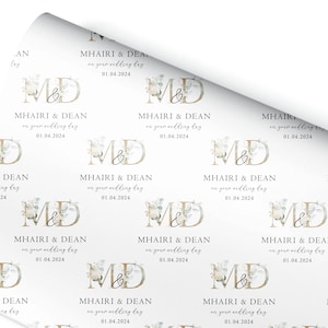 a white wrapping paper with a monogrammed design on it