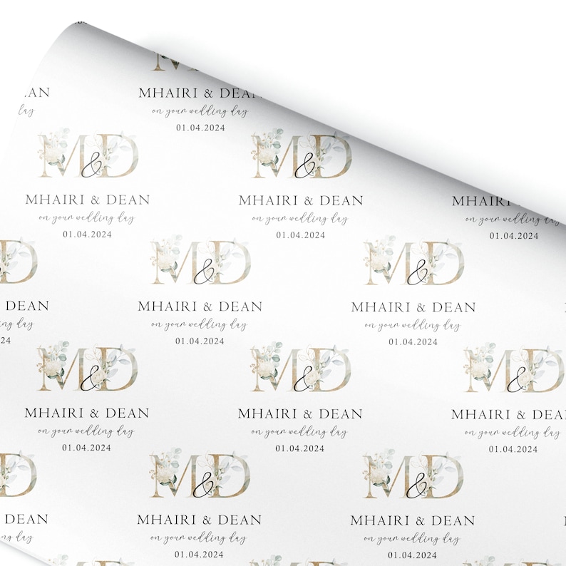 a white wrapping paper with a monogrammed design on it