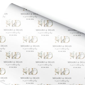 a white wrapping paper with a monogrammed design on it