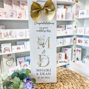 a card with a bow on top of a table