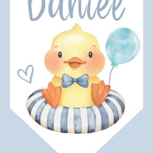 May include: A watercolor banner featuring the name "Daniel" in light blue script. A yellow duckling with an orange beak and feet, wearing a blue bow tie, floats in a striped inner tube and holds a blue balloon. A small blue heart is on the left.