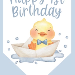 May include: A light blue banner with the text "Happy 1st Birthday." A yellow cartoon duck with an orange beak and feet wears a blue bow tie and sits in a paper boat. Bubbles and water details complete the design.