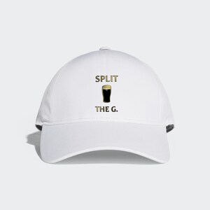 May include: White baseball cap with the text "SPLIT THE G." and a graphic of a glass of beer.