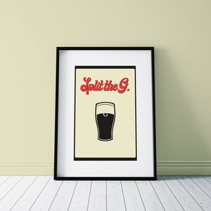 May include: Framed art print featuring a black and white illustration of a pint of beer. The text "Split the G." is in red script above the beer glass. The artwork is displayed in a black frame.