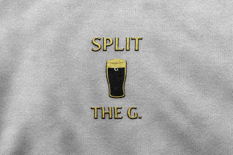 May include: A gray t-shirt with the text "SPLIT THE G." in gold lettering. A black and gold illustration of a glass of beer is between the words.