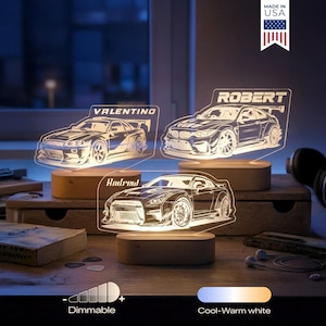May include: Three illuminated car-shaped night lights with personalized names: "Valentino", "Robert", and "Andrei". Each light is mounted on a wooden base. The lights are dimmable and offer a cool-warm white light option. Made in the USA.