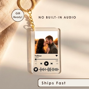 May include: A clear rectangular acrylic keychain featuring a printed photograph of a couple, the song title Yellow by Coldplay, a music playback interface, and a scannable sound wave code. The keychain includes a gold-toned metal ring and chain.