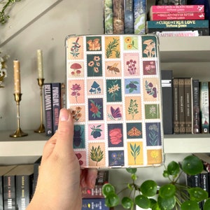 May include: A clear phone case with a colourful design of vintage postage stamps featuring mushrooms, flowers, insects, and leaves.