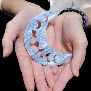 Moon phase ornament made with beautiful blue sky glitter acrylic!