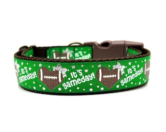 May include: Green dog collar with a brown buckle and white text that says "It's gameday!" with a brown football in a heart shape. The collar is decorated with silver stars.