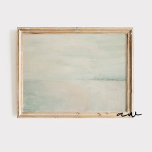 A framed abstract beach landscape hangs with a pastel color palette by Asheville artist Amy Warr. It is the perfect match for a beach themed nursery, beach baby girl nursery, or beach lovers gift.