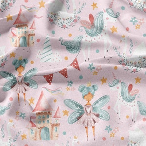 May include: A pink fabric with a repeating pattern of fairies, unicorns, castles, and stars. The fairies are wearing pink dresses and have blue wings. The unicorns are white with blue manes and tails. The castles are pink and have blue roofs. The stars are yellow.