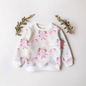 May include: White sweatshirt with a pink and purple octopus print. The octopus is wearing a flower crown. The background is a light blue and white watercolor pattern.