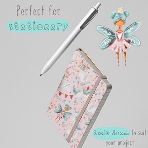 May include: A pink notebook with a whimsical pattern featuring fairies, unicorns, and castles. The notebook has a pink elastic band closure and a white pen is shown next to it.
