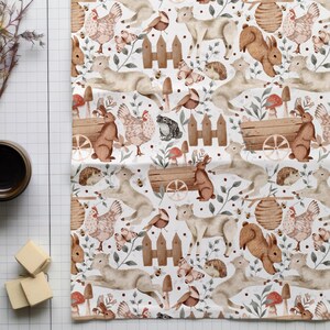 May include: A white fabric with a repeating pattern of watercolor illustrations of woodland animals, including rabbits, deer, birds, and hedgehogs. The animals are surrounded by greenery, flowers, and mushrooms.