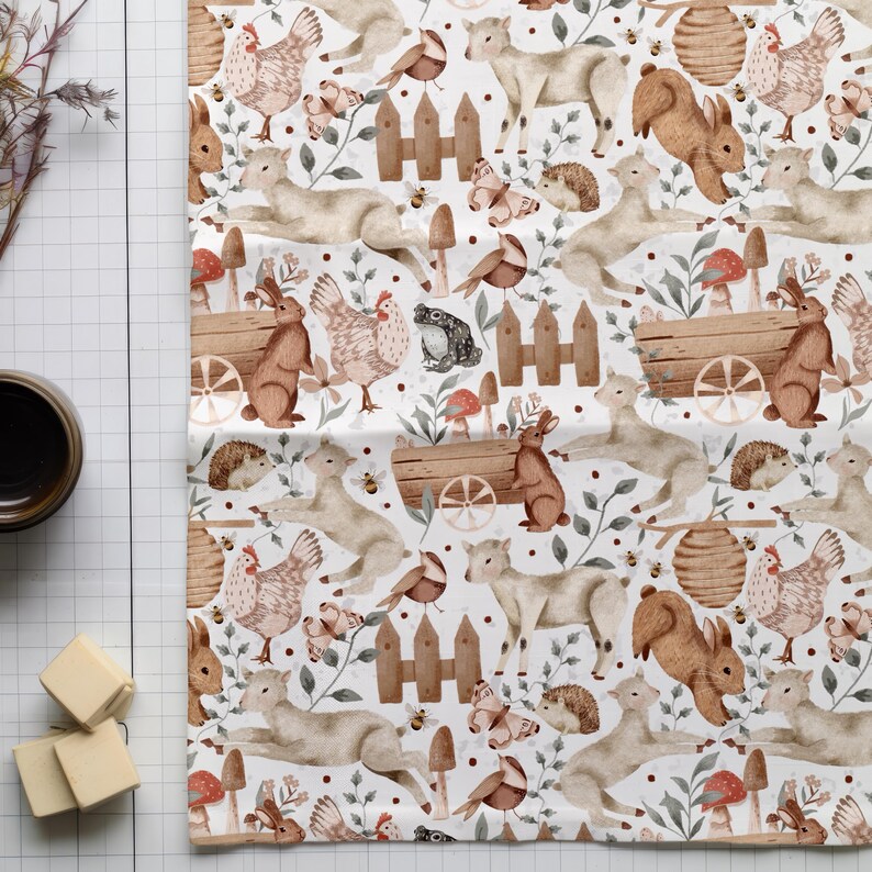 May include: A white fabric with a repeating pattern of watercolor illustrations of woodland animals, including rabbits, deer, birds, and hedgehogs. The animals are surrounded by greenery, flowers, and mushrooms.