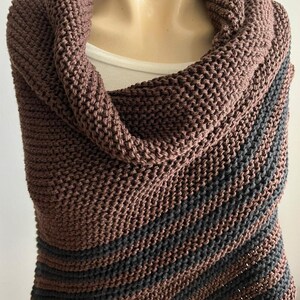 May include: A brown and black striped knitted shawl with a cowl neck.
