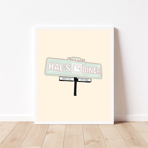 May include: A retro-style diner sign with the text "Hal's Diner" in pink and green. The sign has a clock with the hands pointing to 2:00 and the words "Time to Eat" in red. The sign also has the words "Take Out" and "Eat Here" in black.