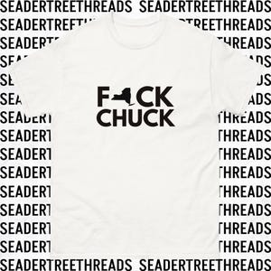 May include: White t-shirt with black text that reads "F*CK CHUCK" with an outline of the state of New York in place of the "C".
