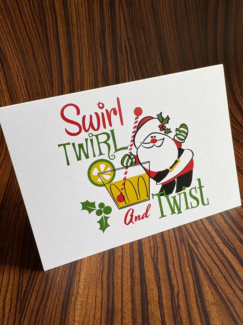 May include: A Christmas card with a cartoon Santa Claus holding a glass of a red and yellow drink with a lime wedge. The text on the card reads "Swirl Twirl and Twist".