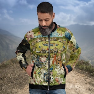 May include: A black bomber jacket with a colorful, detailed print of a painting. The print features a variety of figures and animals in a landscape setting.