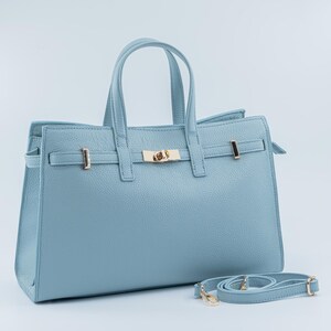 Italian Handmade Leather Bag crafted in Florence from genuine Italian leather, this elegant light blue top handle bag & tote bag blends timeless design with everyday functionality. Featuring structured lines, a refined gold-tone turn-lock closure, and double top handles, it offers a spacious interior with secure zip closure. A versatile leather tote bag made in Italy, perfect for work, city wear, or as a thoughtful gift for her.