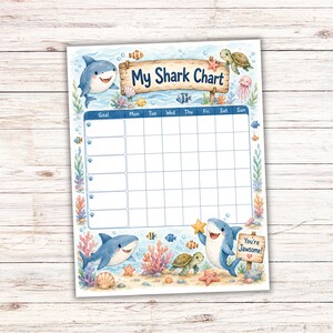 May include: A rectangular chore chart titled My Shark Chart with a blue grid for tracking goals throughout the week. The design features watercolor illustrations of sharks, sea turtles, jellyfish, coral, and fish, with a sign saying You're Jawsome!
