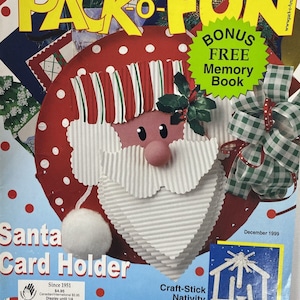 May include: A magazine cover featuring a red and white Santa Claus card holder craft project. The magazine is titled "Pack-o-Fun" and the cover text reads "41 Easy Gifts You Can Make". The magazine also includes a bonus free memory book.
